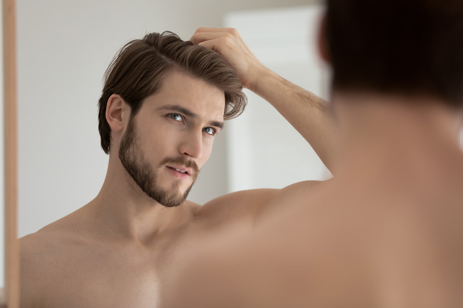 Man looking at his hair